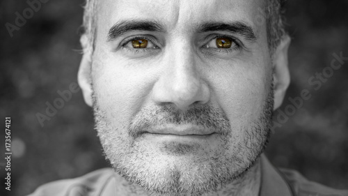 Black and white portrait of a middle-aged man highlighting his eyes in color