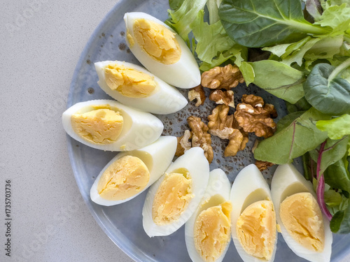 sliced boiled eggs, walnuts, fresh green salad for breakfast