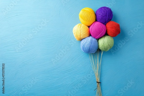 Colorful yarn balls arranged as balloon shapes


