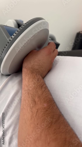 Patient undergoing innovative pulsed electromagnetic field therapy on wrist