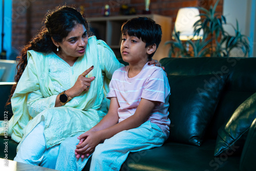 Photos Indian Mom gently scolds child while teaching good habits, showing care and pare
