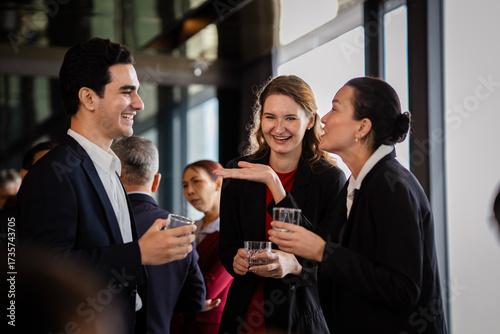 Professionals meeting at an evening event, emphasizing collaboration, leadership, and organizational values. Business people relaxed talk at party on rooftop restaurant.