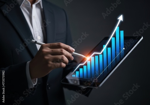 Businessman analyzing upward trending financial growth chart on a tablet isolated on white background