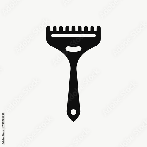 Black ice scraper against white background provides clear visual. Ice scraper helps with winter car maintenance.