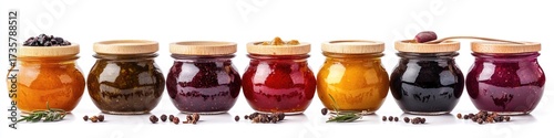 Assorted colorful jams or preserves in glass jars with wooden lids