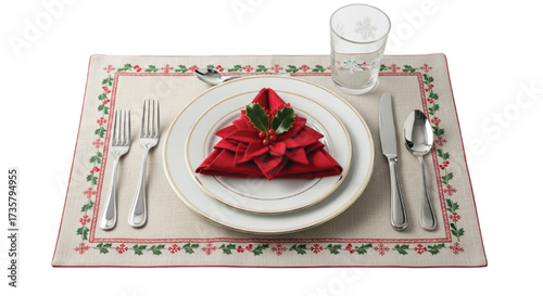 Elegant Christmas table setting with festive tree-shaped napkin and holly berries