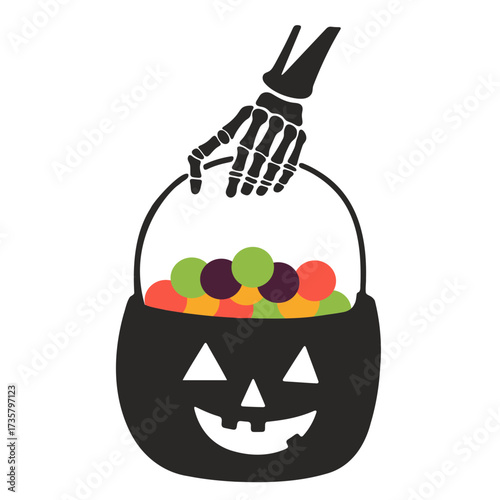 A halloween bucket filled with candy being held by a skeleton hand on a white background scene view