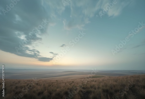Serene Dawn over Rolling Hills and Whispering Grassland