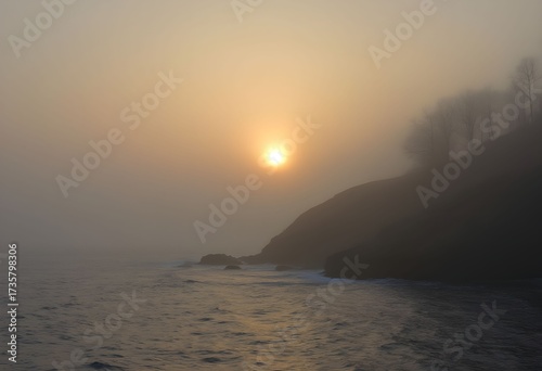 Misty Coastal Sunrise: Golden Light Pierces Through Ocean Fog