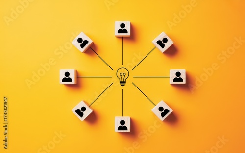 Wooden blocks with people icons linked to a central lightbulb, symbolizing teamwork, brainstorming, innovation, and creative collaboration for a new idea