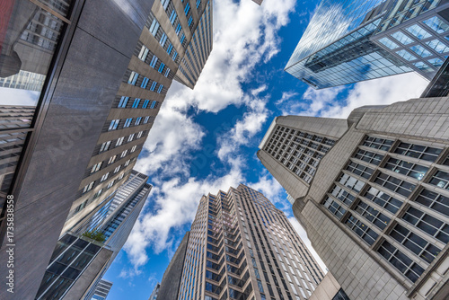  Front street level wide angle view of highrise buildings in Manhattan, New York, USA.