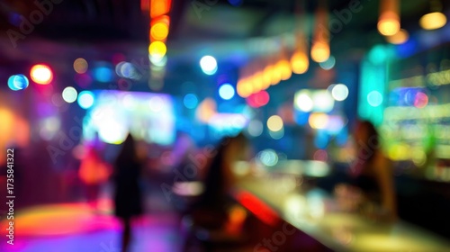 Wallpaper Mural A vibrant, blurred scene of a nightlife venue, showcasing colorful lights and silhouettes of people enjoying a lively atmosphere. Torontodigital.ca