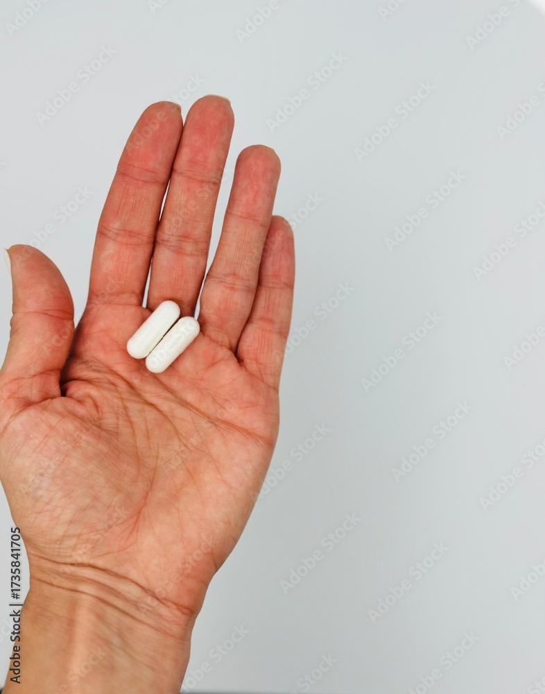Naklejka premium hand with pill. Place for text 