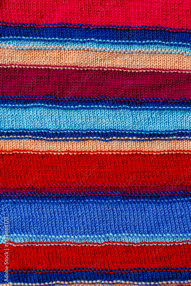 Obraz premium Knitted striped fabric texture, multicolor handmade textile background, stylish autumn winter clothing