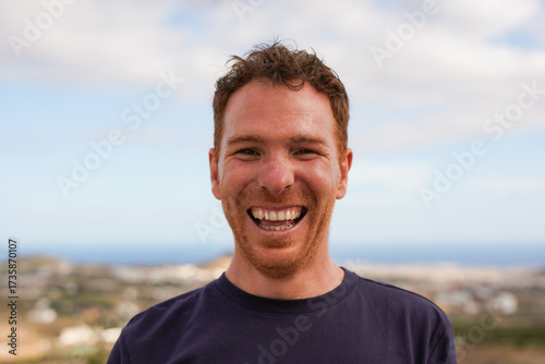 Happy young redhair man smiling on camera with view in background - Portrait of redhead boy outdoor