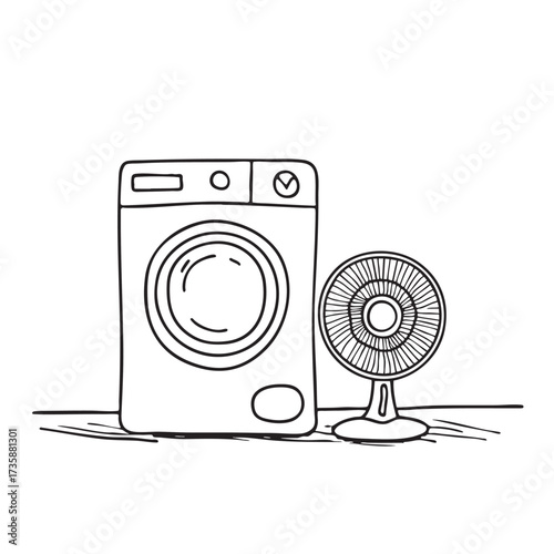 A washing machine near a fan placed on the floor