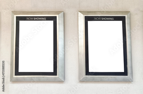 Two mock-up poster frames on a gray cinema wall