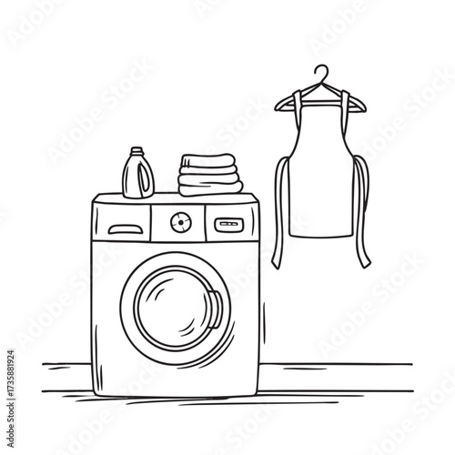 A washing machine near a wall hook with hanging aprons and cloths