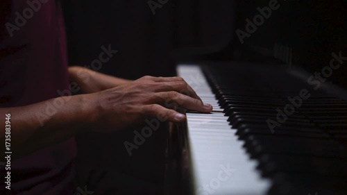 Close-Up of Hands Playing Piano Keys Under Low Light – Music Practice and Performance Concept