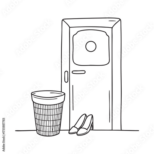 A wastebasket near a door with a pair of shoes placed nearby