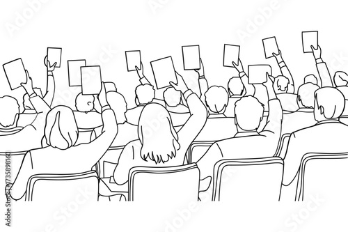 Audience members holding up cards in a meeting or presentation