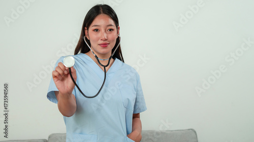 Nurse demonstrating stethoscope use in healthcare setting educational image professional environment close-up view