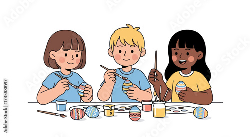 Three diverse children happily painting colorful Easter eggs together at a table.