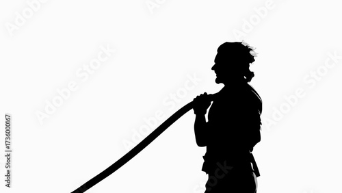 Powerful silhouette of a strong warrior wielding a traditional katana sword with confidence and discipline