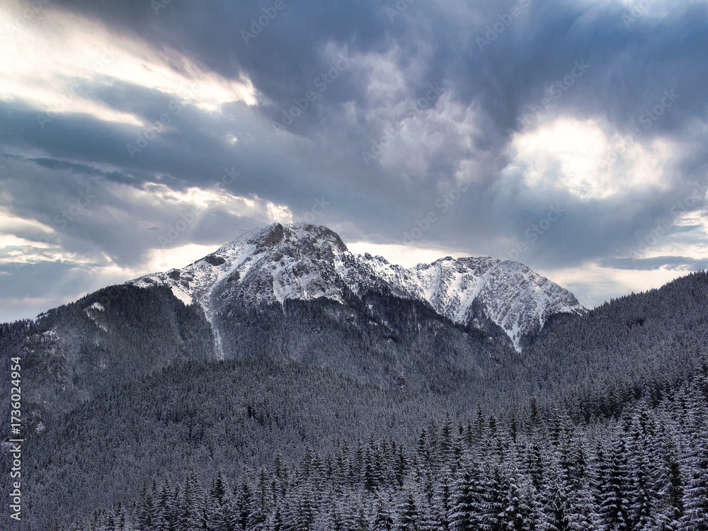Fototapeta premium clouds over the snow-covered mountain peaks