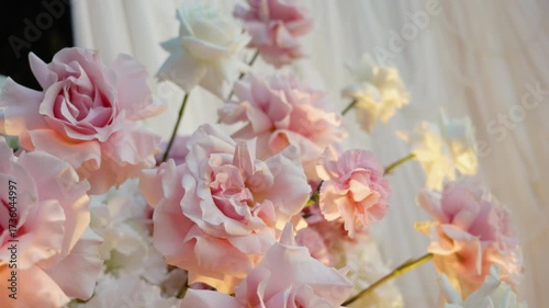 wedding arch of white rose flowers on the river bank before the wedding ceremony of the bride and groom, festive romantic decor