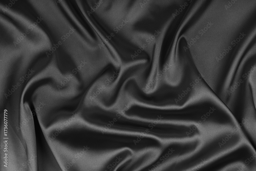 Fototapeta premium Crumpled, wrinkled black colored glossy silk satin texture. Shiny smooth fabric with soft folds, cloth with wave drapery. Elegant and rich background, wallpaper, backdrop. Flat lay, top view