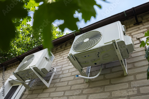 Two air source heat pumps installed on the exterior