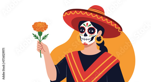 A woman in traditional attire and makeup holds a marigold flower.