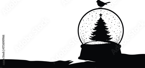 Silhouette of christmas tree inside snow globe with bird