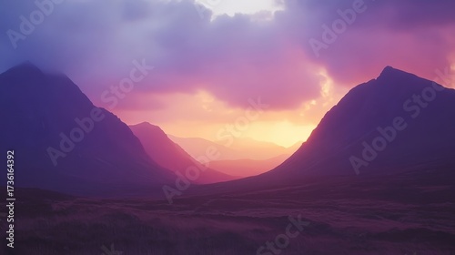 Breathtaking sunset over mountains, painting the sky with colorful hues of pink and purple, creating a serene nature scene.