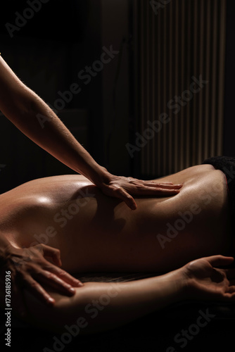 Relaxing back massage in spa salon. Professional therapist performing luxury wellness treatment for stress relief and relaxation.