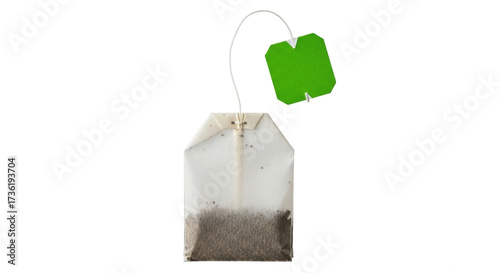 Fotografie Isolated tea bag with green label for hot beverage preparation in the morning or