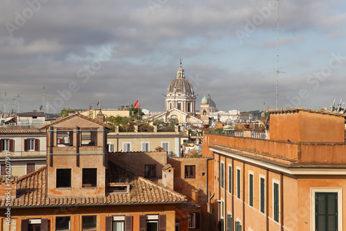 This view from the Spanish Steps highlights the rooftops of Rome's historic center and the dome of St. Peter's Basilica.