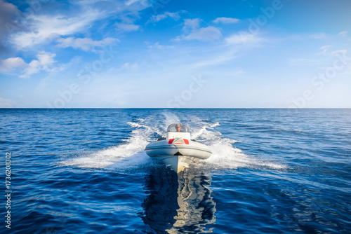 Front view of a sports RIB boat cruising with high speed over the cam ocean with copy space