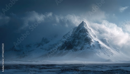 Wallpaper Mural Snowy mountain peak piercing stormy, cloud-filled sky. Windswept landscape. Dramatic Torontodigital.ca