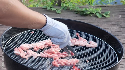 Korean BBQ style. Asian grilling barbecue on mesh grill of charcoal fire. Korean traditional food.