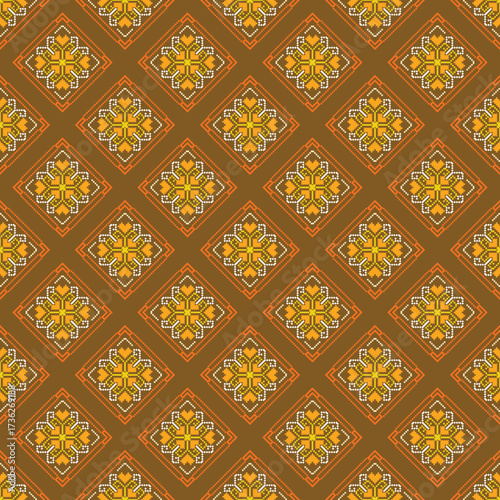 Pixel art textile pattern in brown, orange, yellow, and white, arranged in diamond shapes with floral and geometric details.