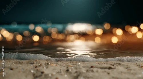 Close-up of ocean waves washing over a sandy beach with golden bokeh lights in the background (AI Generated)