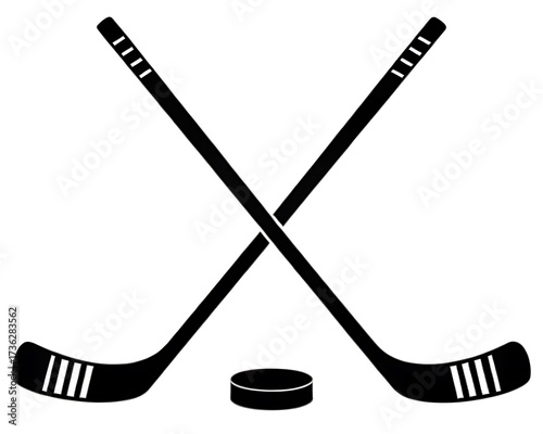 Two crossed hockey sticks and a puck on a white background