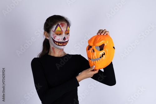 Woman in black shirt holding Halloween mask