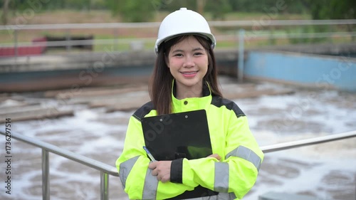 Engineer inspecting wastewater treatment plant and recording data for environmental monitoring. Concept of water management, industrial inspection, and sustainability process.