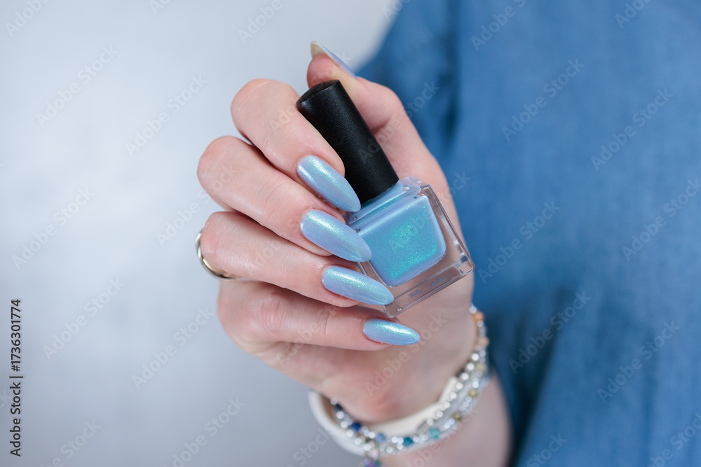 Fototapeta premium beautiful hand with long nails and light baby blue manicure