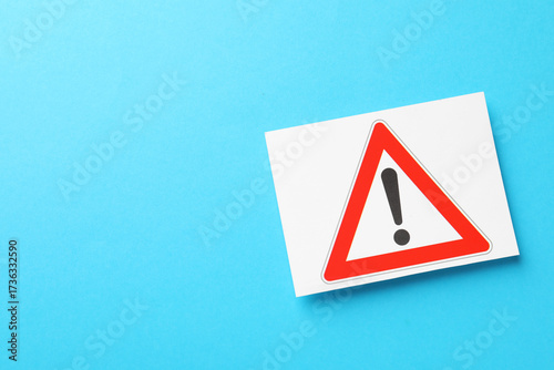 Risk. Sheet of paper with warning sign on light blue background, top view and space for text Free Download Risk. Sheet of paper with warning sign on light blue background, top view and space for text - GFXLoad