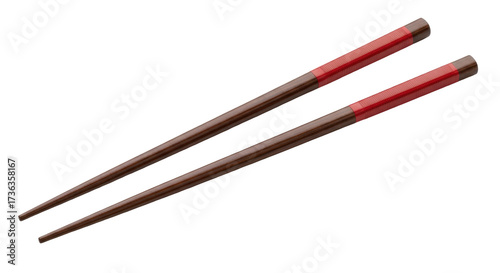 Isolated pair of wooden chopsticks with red band, traditional Asian culinary utensils