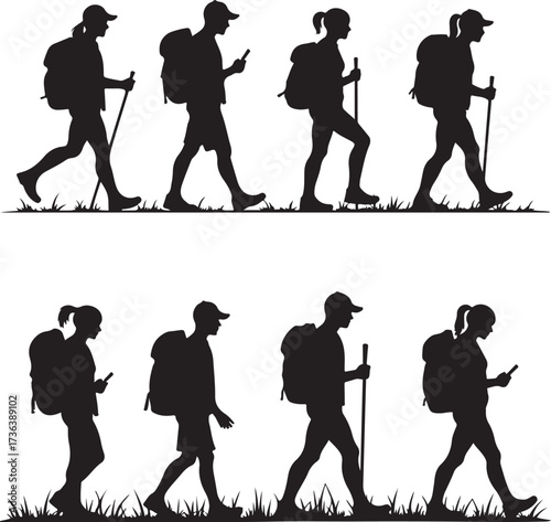 Silhouettes of hikers with backpacks walking on grass